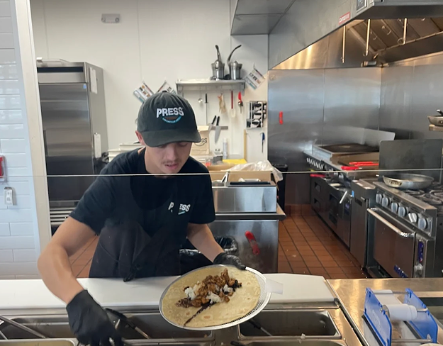 Press team member preparing food in the kitchen
